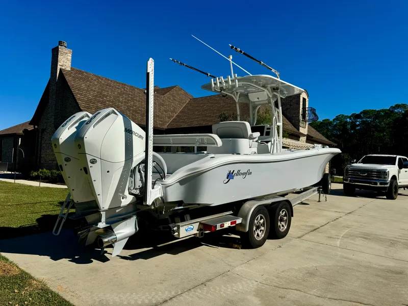 Slide: The Image of 2020 Yellowfin 26 Hybrid boat on trailer, parked in driveway. - 5