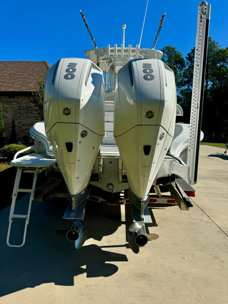 Slide: The Image of 2020 Yellowfin 26 Hybrid boat with dual outboard engines in driveway. - 6