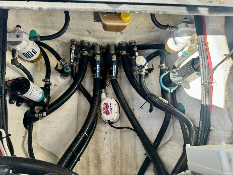 Slide: The Image of Engine compartment of 2020 Yellowfin 26 Hybrid with hoses and filters visible. - 9