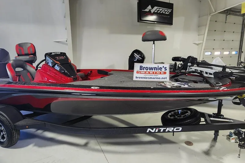 The Image of 2025 Nitro Z19 boat in showroom, featuring sleek red and black design. - 1