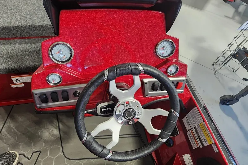 Slide: The Image of Red Nitro Z19 2025 boat dashboard with steering wheel and gauges. - 11