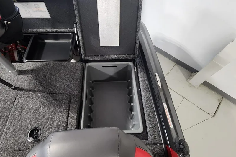 Slide: The Image of 2025 Nitro Z19 boat storage compartment with open lid, showcasing interior design. - 17