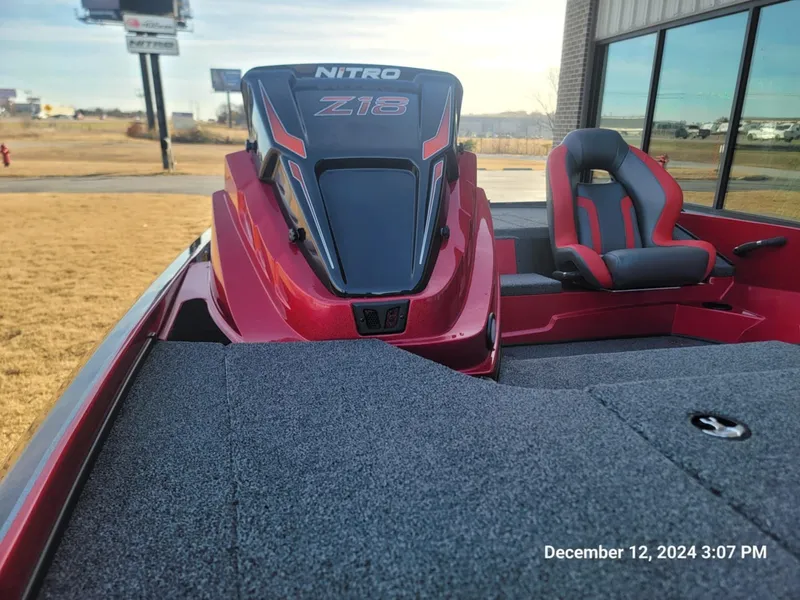 Slide: The Image of Red Nitro Z18 boat interior, 2025 model, with seating and dashboard. - 2