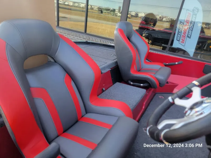 Slide: The Image of 2025 Nitro Z18 boat interior with red and gray seats, steering wheel visible. - 6