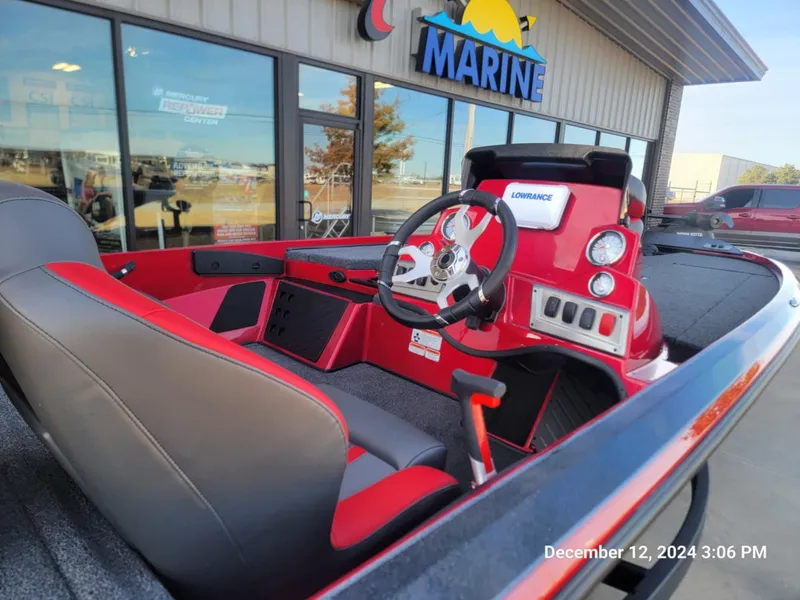 Slide: The Image of 2025 Nitro Z18 boat interior with red dashboard and steering wheel at a marine dealership. - 7