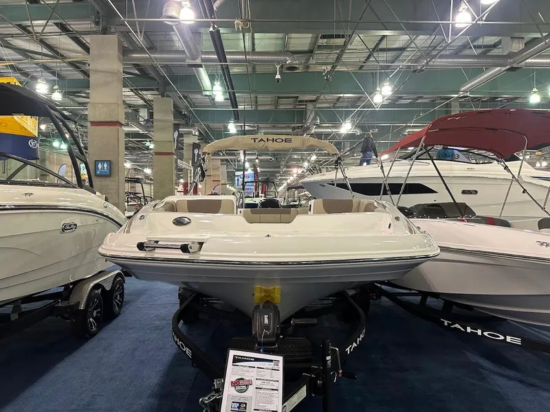 Slide: The Image of 2025 Tahoe 1950 boat displayed at an indoor boat show. - 1