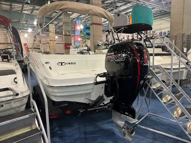 Slide: The Image of 2025 Tahoe 1950 boat with powerful outboard motor displayed at a boat show. - 5
