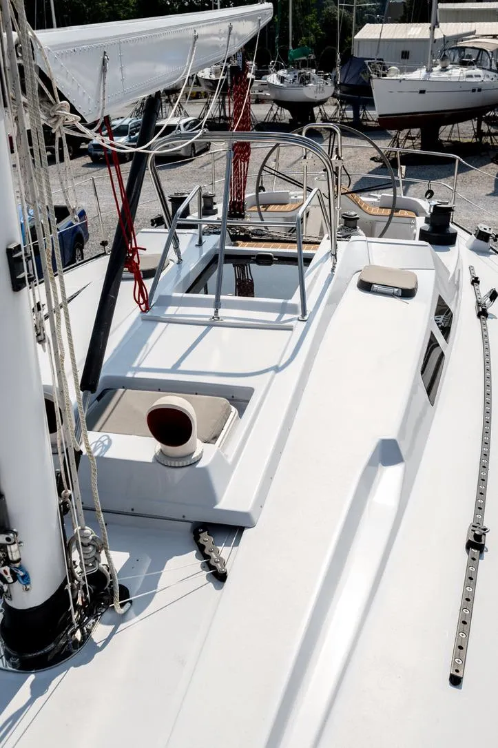 Slide: The Image of 1977 Baltic 42 sailboat deck with rigging and steering wheel in a marina. - 10