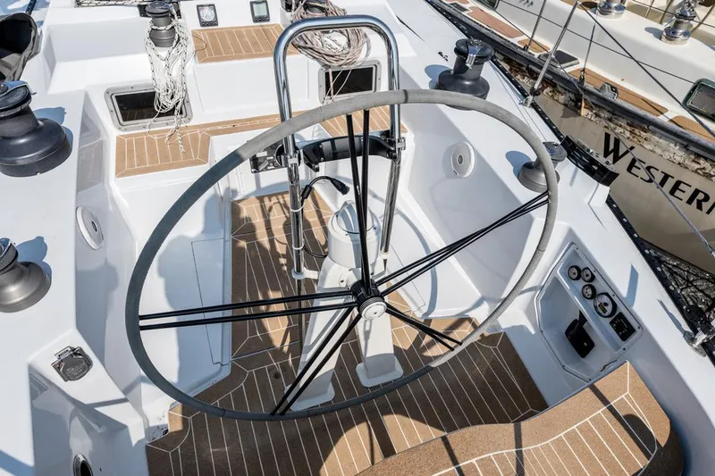 Slide: The Image of Cockpit of a 1977 Baltic 42 sailboat with large steering wheel and teak flooring. - 11