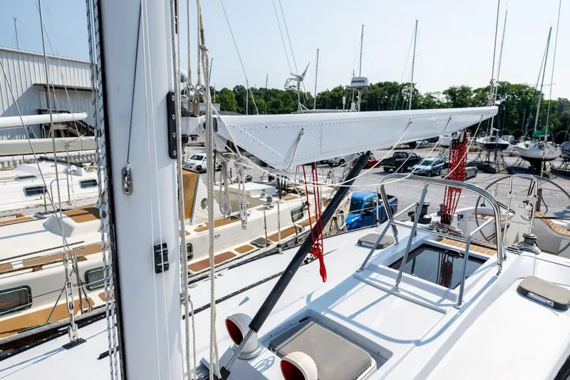 Slide: The Image of Baltic 42 sailboat from 1977 docked in a marina, surrounded by other boats. - 15