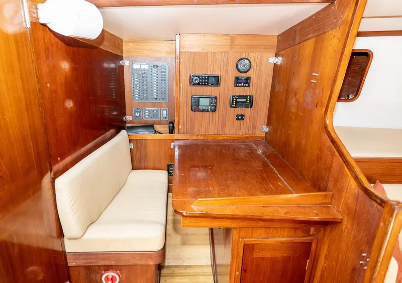 Slide: The Image of 1977 Baltic 42 yacht interior with navigation station and wooden furnishings. - 20