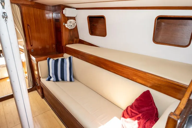 Slide: The Image of Cozy interior of 1977 Baltic 42 sailboat with wooden accents and comfortable seating. - 21