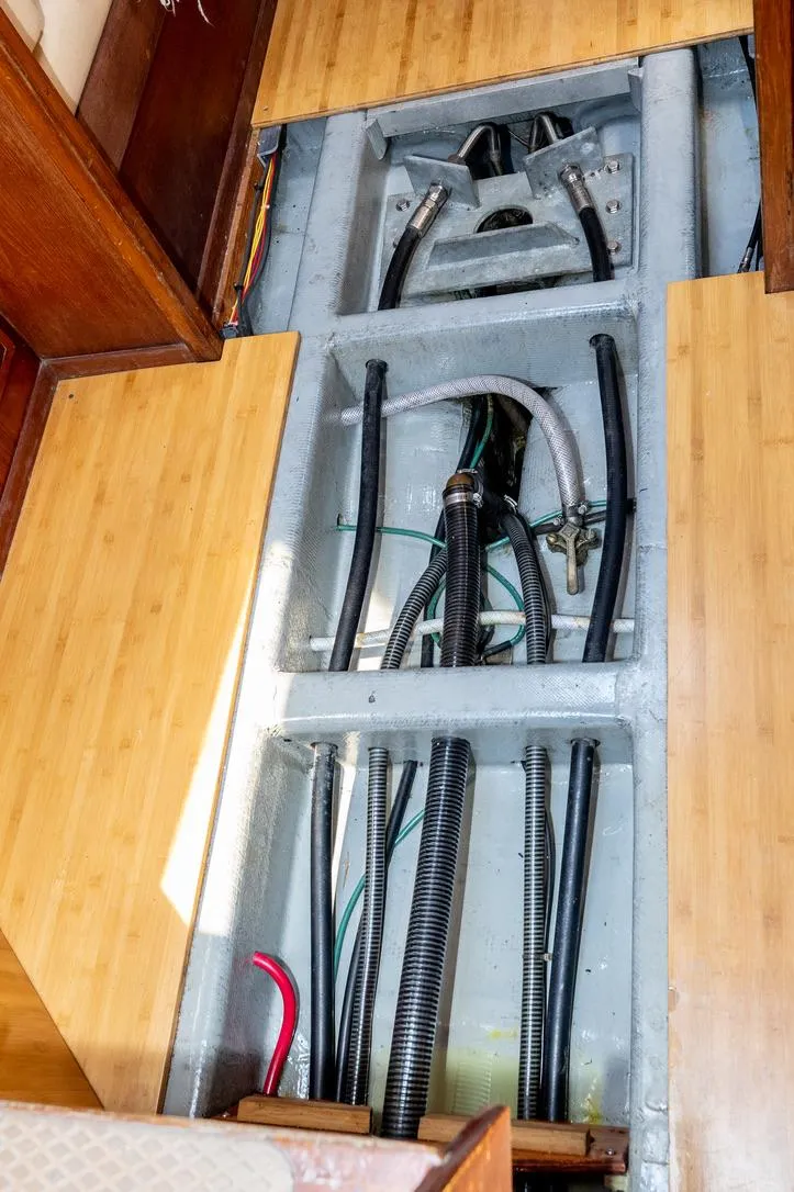 Slide: The Image of Interior view of 1977 Baltic 42 yacht showing exposed underfloor piping and wiring. - 25