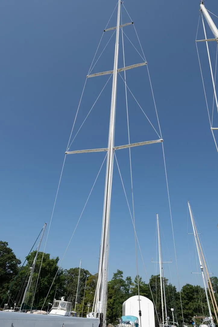 Slide: The Image of Tall mast of a 1977 Baltic 42 sailboat against a clear blue sky. - 9