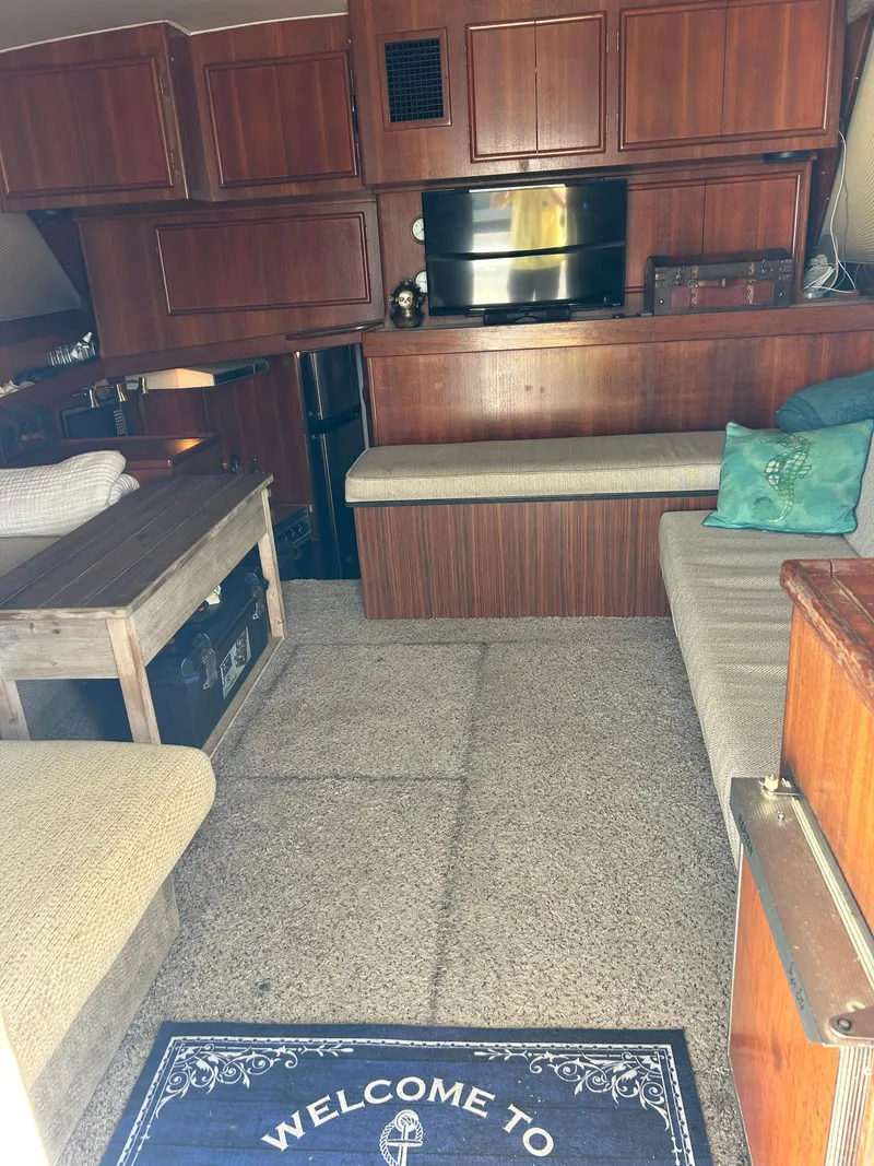 Slide: The Image of Cozy 1989 Post 43 yacht interior with wood paneling, seating, and welcome mat. - 18