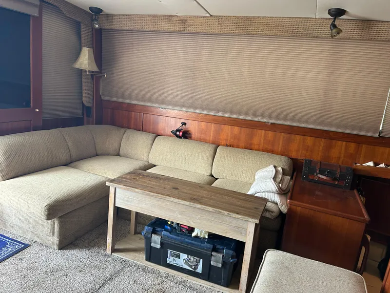 Slide: The Image of Cozy boat interior with beige sectional sofa, wooden table, and vintage decor. - 20