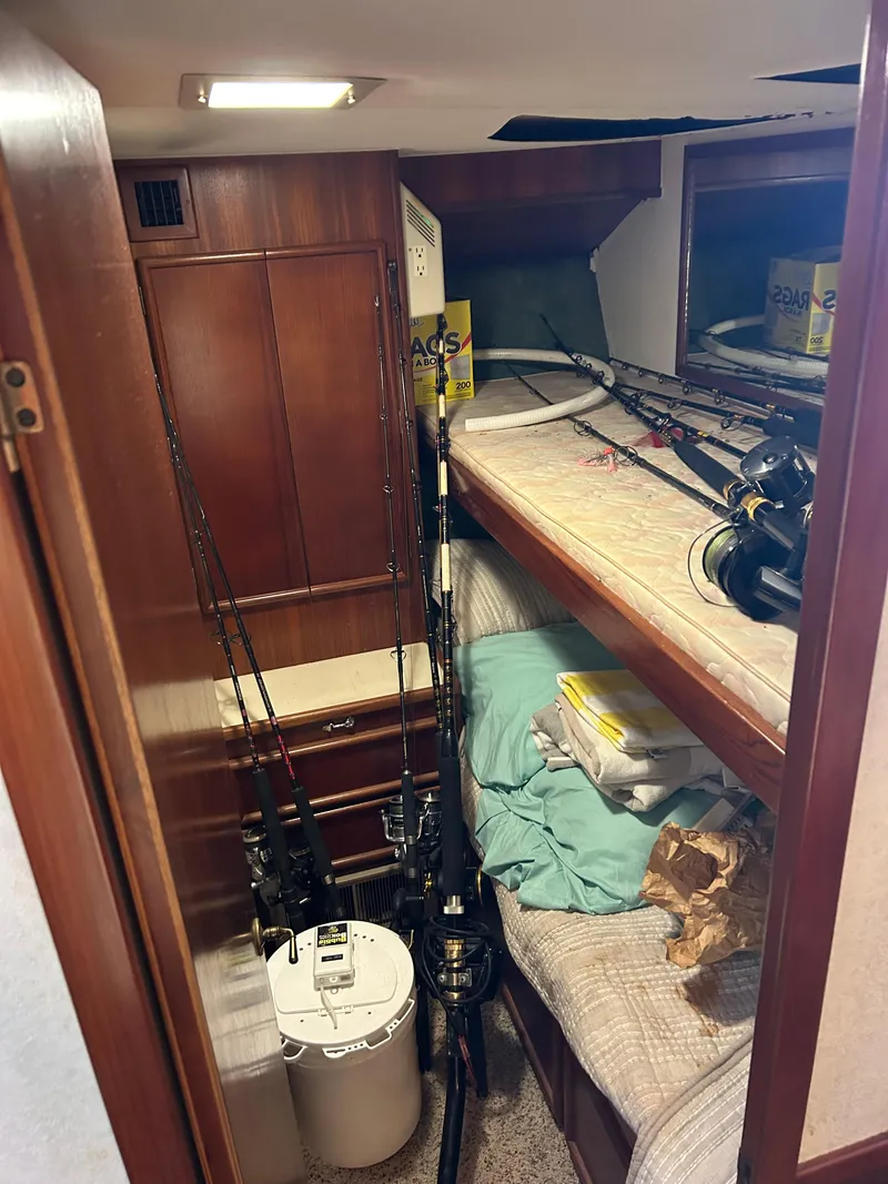 Slide: The Image of Boat cabin interior with fishing rods, bunk beds, and storage, Post model 43, 1989. - 26