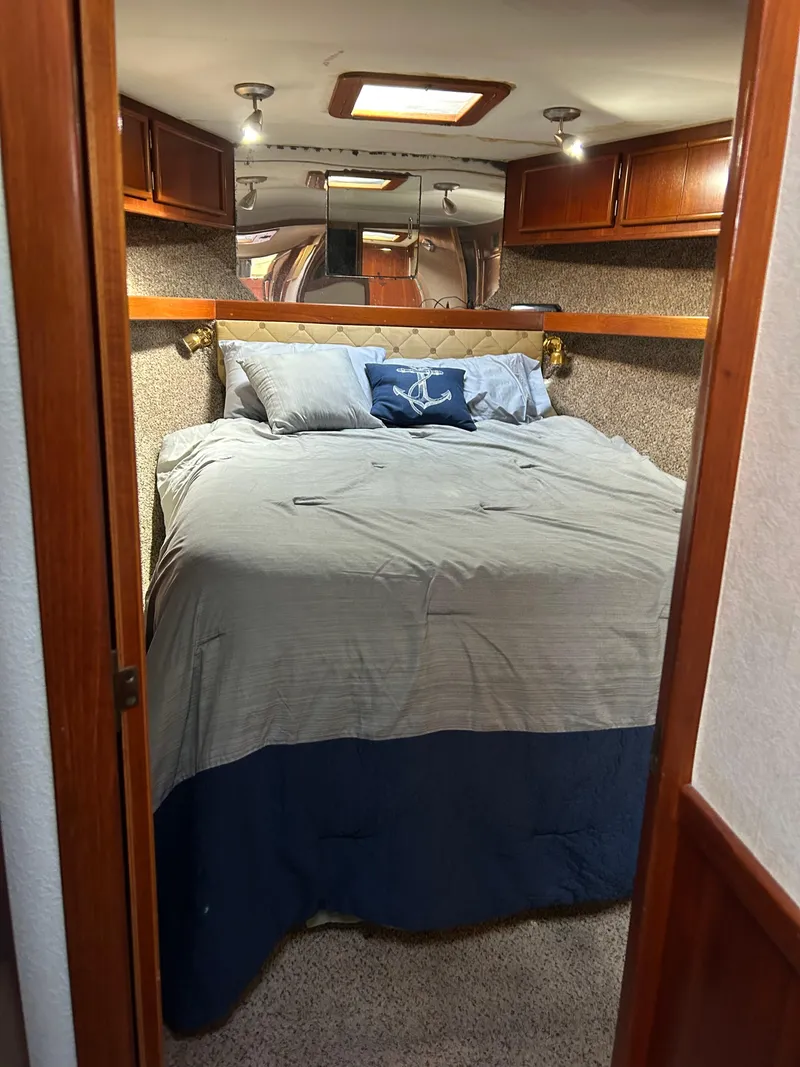 Slide: The Image of Cozy bedroom in 1989 Post 43 yacht with plush bedding and wooden cabinets. - 27