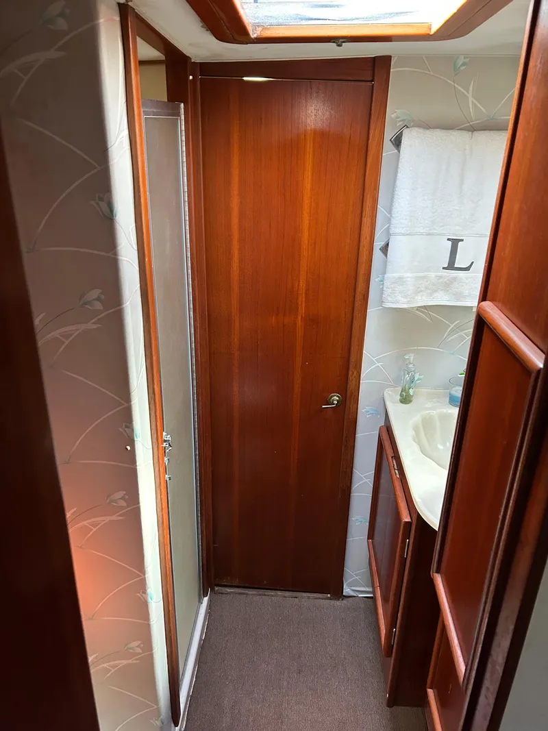 Slide: The Image of Narrow boat bathroom with wooden door, sink, and towel, Post 43, 1989 model. - 32