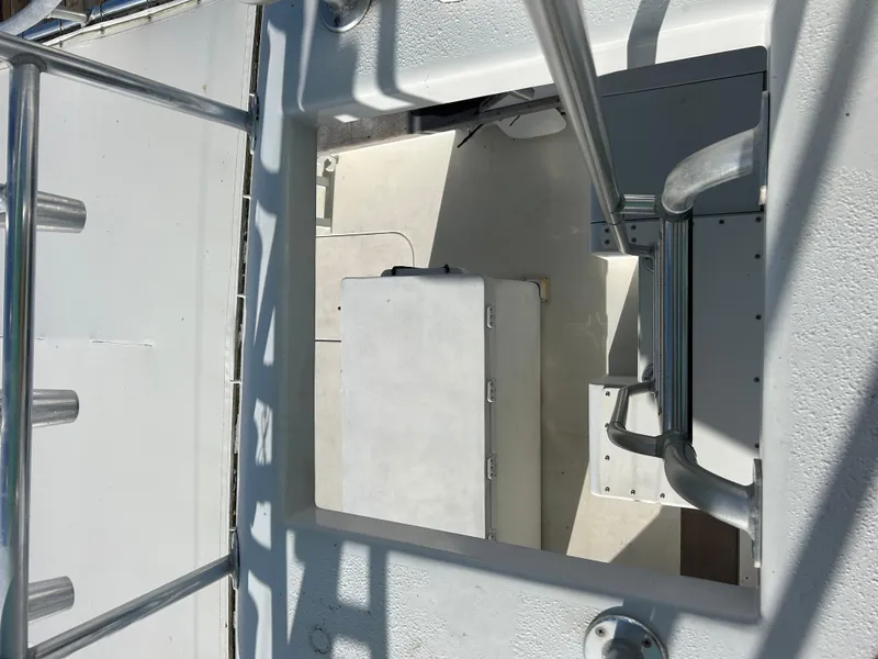 Slide: The Image of View of a 1989 Post 43 boat deck with metal railings and storage compartment. - 6