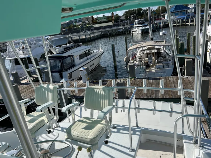 Slide: The Image of View from 1989 Post 43 yacht's deck overlooking marina with docked boats. - 7