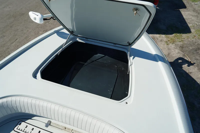 Slide: The Image of 2016 Contender 25 Bay boat with open storage compartment. - 12