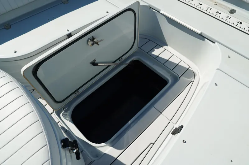 Slide: The Image of Open storage compartment on 2016 Contender 25 Bay boat deck. - 19