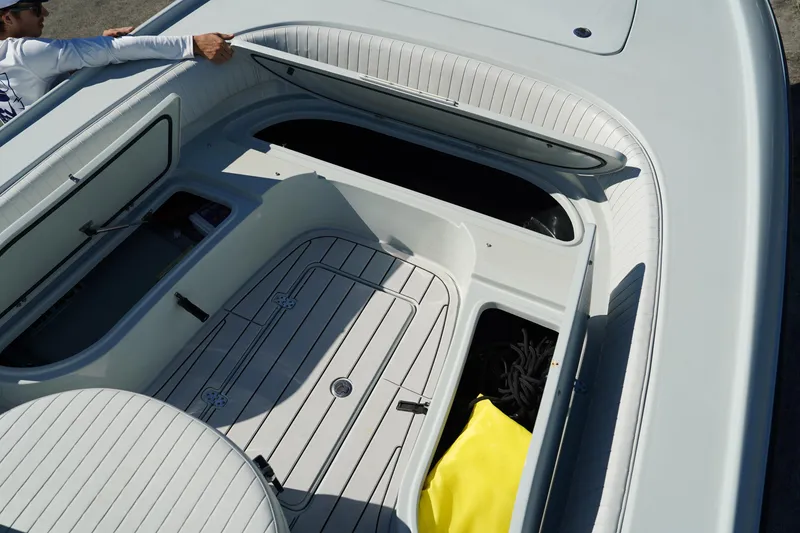 Slide: The Image of 2016 Contender 25 Bay boat interior with open storage compartments. - 20