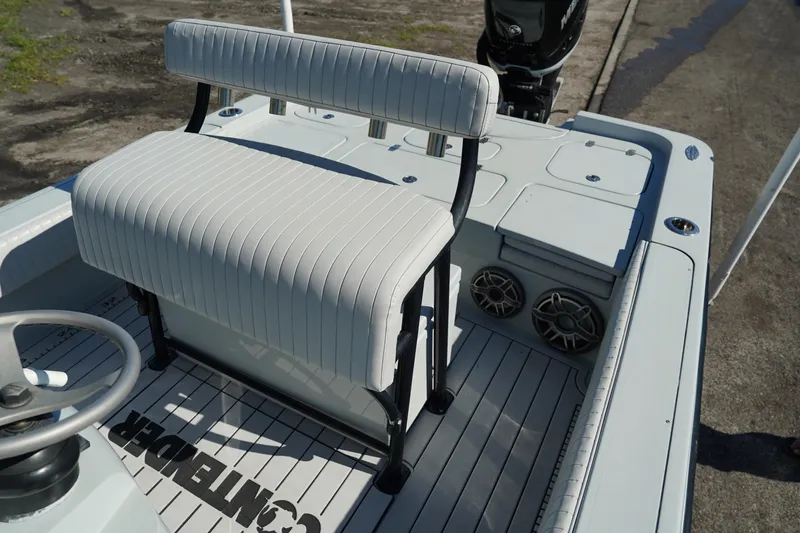 Slide: The Image of 2016 Contender 25 Bay boat interior with white seating and steering wheel. - 25