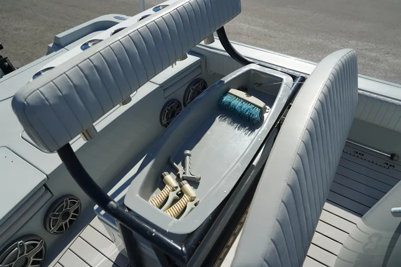 Slide: The Image of 2016 Contender 25 Bay boat storage compartment with cleaning supplies. - 27