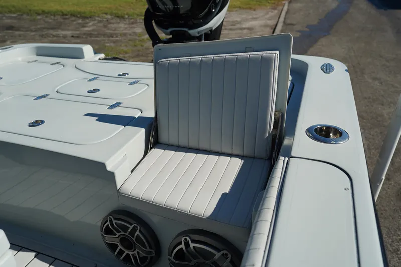 Slide: The Image of Contender 25 Bay 2016 boat interior with cushioned seat and storage compartments. - 29