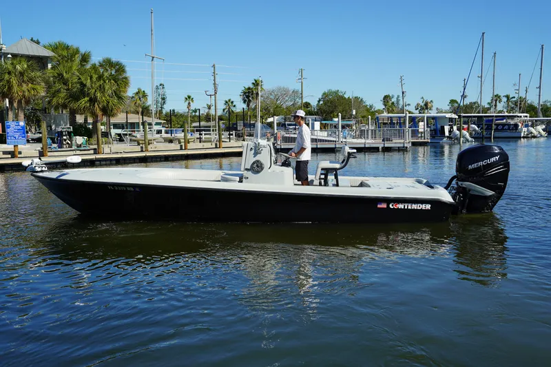 Slide: The Image of 2016 Contender 25 Bay boat on calm water near marina. - 3