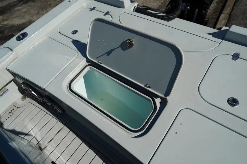 Slide: The Image of Open storage compartment on 2016 Contender 25 Bay boat deck. - 30