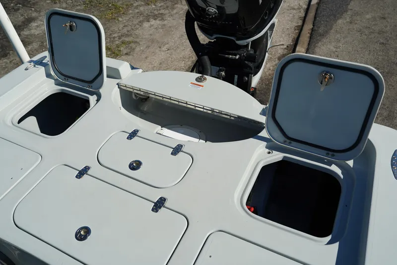 Slide: The Image of 2016 Contender 25 Bay boat storage compartments and motor detail. - 33