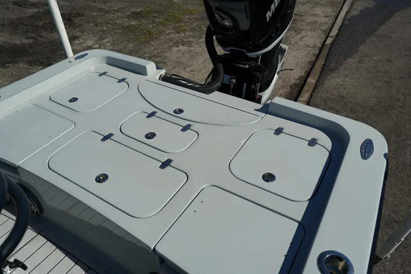 Slide: The Image of 2016 Contender 25 Bay boat deck with storage compartments and motor. - 35