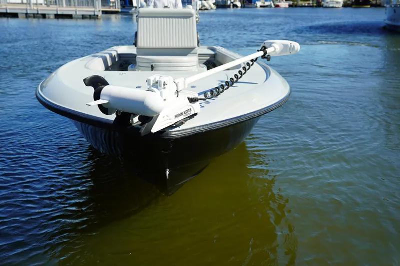 Slide: The Image of 2016 Contender 25 Bay boat docked on calm water. - 8