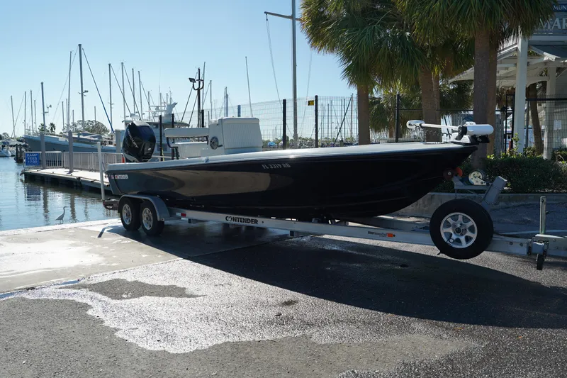 Slide: The Image of 2016 Contender 25 Bay boat on trailer at marina dock. - 9