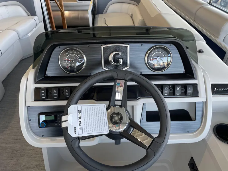 Slide: The Image of 2025 Godfrey Sweetwater 2086 C boat dashboard with steering wheel and instrument panel. - 10