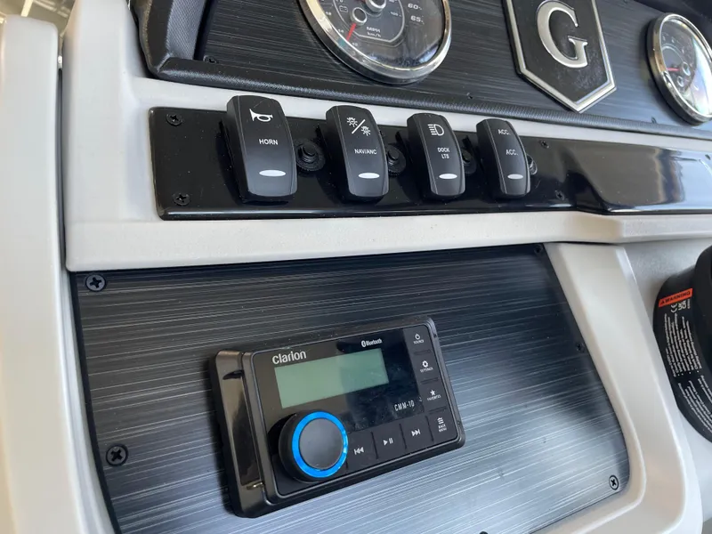 Slide: The Image of Control panel of 2025 Godfrey Sweetwater 2086 C boat with switches and Clarion audio system. - 11