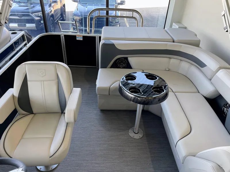 Slide: The Image of Luxurious interior of 2025 Godfrey Sweetwater 2086 C pontoon boat with plush seating and table. - 12