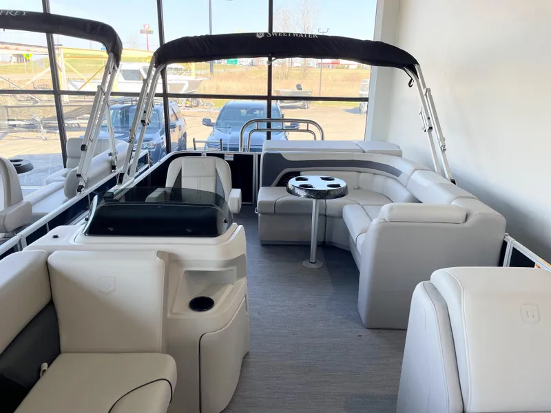 Slide: The Image of 2025 Godfrey Sweetwater 2086 C pontoon boat interior with plush seating and table. - 4