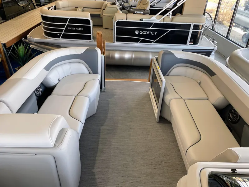 Slide: The Image of 2025 Godfrey Sweetwater 2086 C pontoon boat interior with plush seating and modern design. - 7