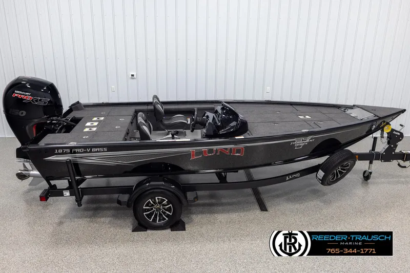 Slide: The Image of 2025 Lund 1875 Pro V Bass XS boat on trailer, side view in showroom. - 1