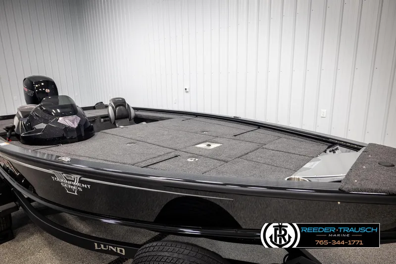 Slide: The Image of 2025 Lund 1875 Pro V Bass XS boat in showroom, featuring spacious deck and modern design. - 11