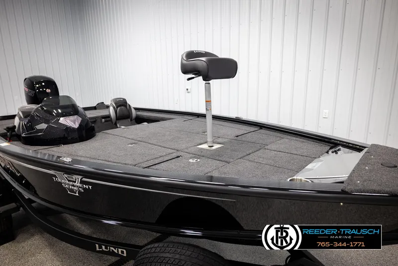 Slide: The Image of 2025 Lund 1875 Pro V Bass XS boat in showroom, featuring spacious deck and modern design. - 13
