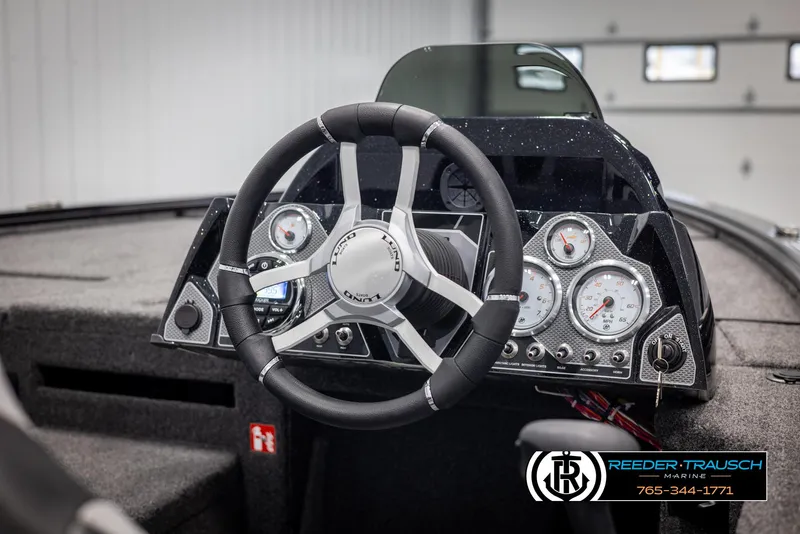 Slide: The Image of 2025 Lund 1875 Pro V Bass XS boat dashboard with steering wheel and gauges. - 18