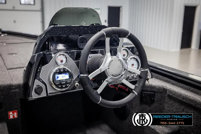 Slide: The Image of 2025 Lund 1875 Pro V Bass XS boat dashboard with steering wheel and gauges. - 19