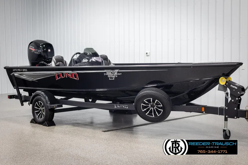 Slide: The Image of 2025 Lund 1875 Pro V Bass XS boat on trailer in showroom. - 2