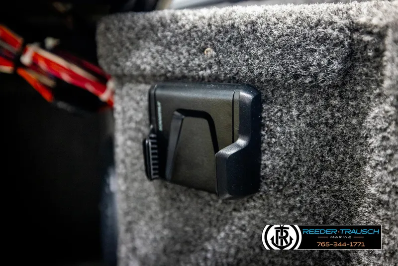 Slide: The Image of 2025 Lund 1875 Pro V Bass XS interior detail with carpeted surface and accessory mount. - 25