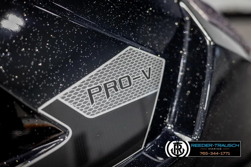 Slide: The Image of 2025 Lund 1875 Pro V Bass XS boat detail with logo and speckled finish. - 29